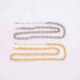 May include: Two necklaces, one silver-colored and one gold-colored, are displayed against a white background. Both necklaces feature a chain link design. The silver necklace is positioned above the gold necklace.