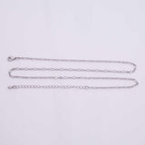 May include: A silver-colored necklace with three strands of varying chain styles. The top strand features small oval links, the middle strand has elongated oval links, and the bottom strand is a series of small circular links. The necklace has a lobster clasp and an extender chain.
