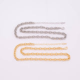 May include: Two necklaces: one silver-colored and one gold-colored. Both feature a chain link design. The necklaces are displayed on a white background. The gold necklace is below the silver necklace.