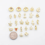 May include: A collection of gold-colored charms with various sea-themed designs, including seashells, starfish, seahorses, and fish. Some charms feature colorful gemstones or pearls. A coin is included for size reference.