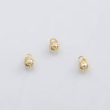 May include: Three small, gold-colored volleyball charms with a textured surface and a loop at the top for attaching to jewelry. The charms are set against a white background.