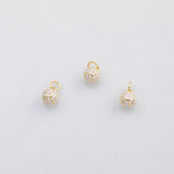 May include: Three gold-colored volleyball charms with white and gold detailing. Each charm has a small loop at the top for attaching to a necklace or bracelet. The volleyballs have a classic design.