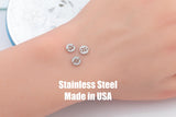 May include: Three small, round, stainless steel charms with etched zodiac symbols: Libra, Gemini, and Cancer. The charms are displayed on a light skin tone. Text at the bottom reads "Stainless Steel Made in USA".