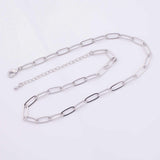 May include: A silver-colored chain necklace with elongated oval links. The necklace has a lobster clasp closure and an adjustable chain. The links alternate between solid silver and black-filled sections, creating a modern design.