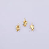 May include: Three small gold-toned metal charms, each shaped like a hand with the middle finger extended in a gesture. Each charm features a small circular loop at the base for attachment, with a polished, reflective surface finish throughout.